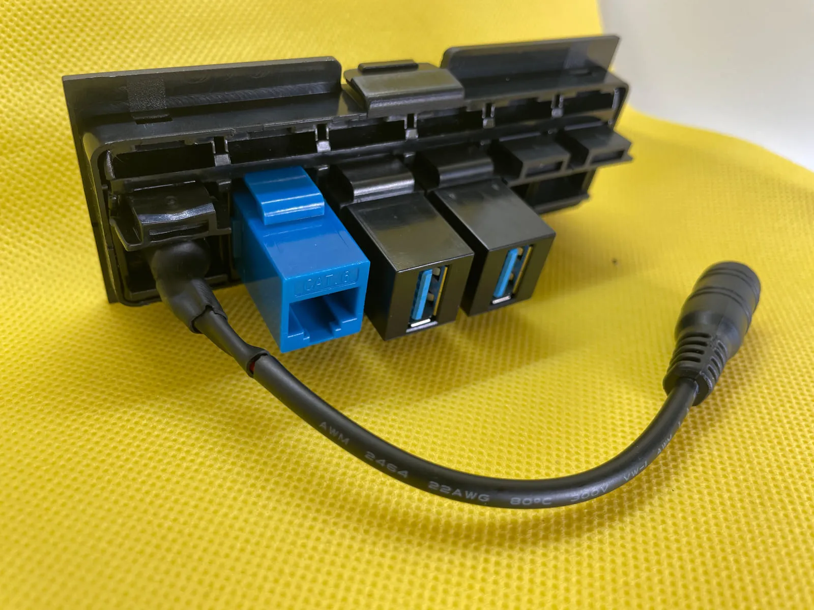 Back view of patch panel with USB, Ethernet, and custom barrel jack keystone inserts