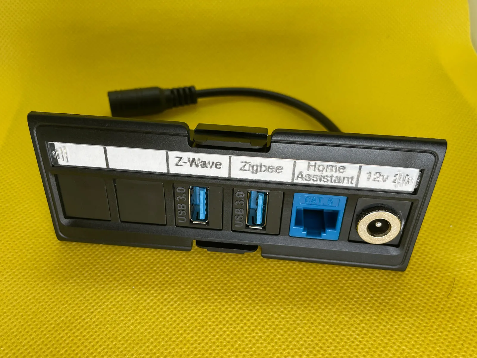 Front view of patch panel with USB, Ethernet, and custom barrel jack keystone inserts