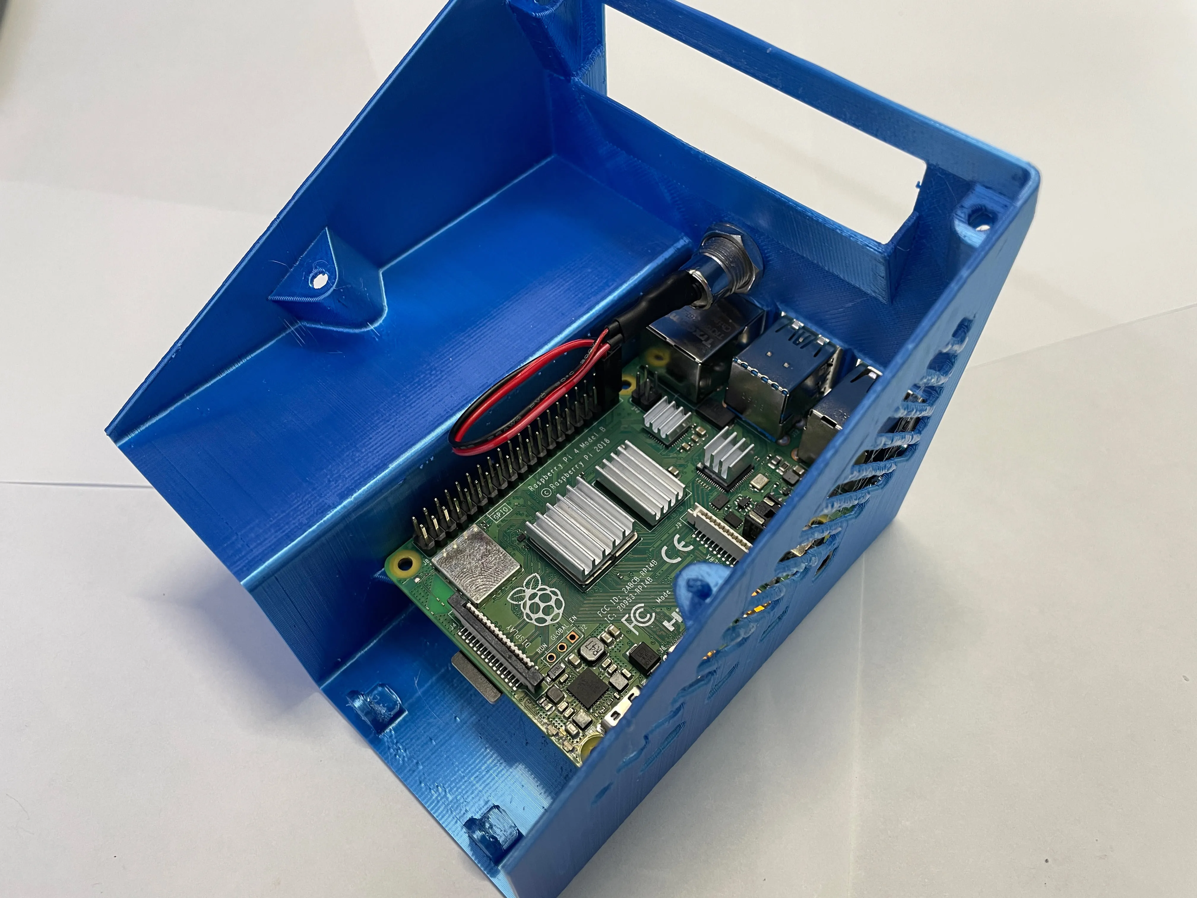 Top view of the Raspberry Pi 4 in the printed enclosure and the female barrel connector installed
