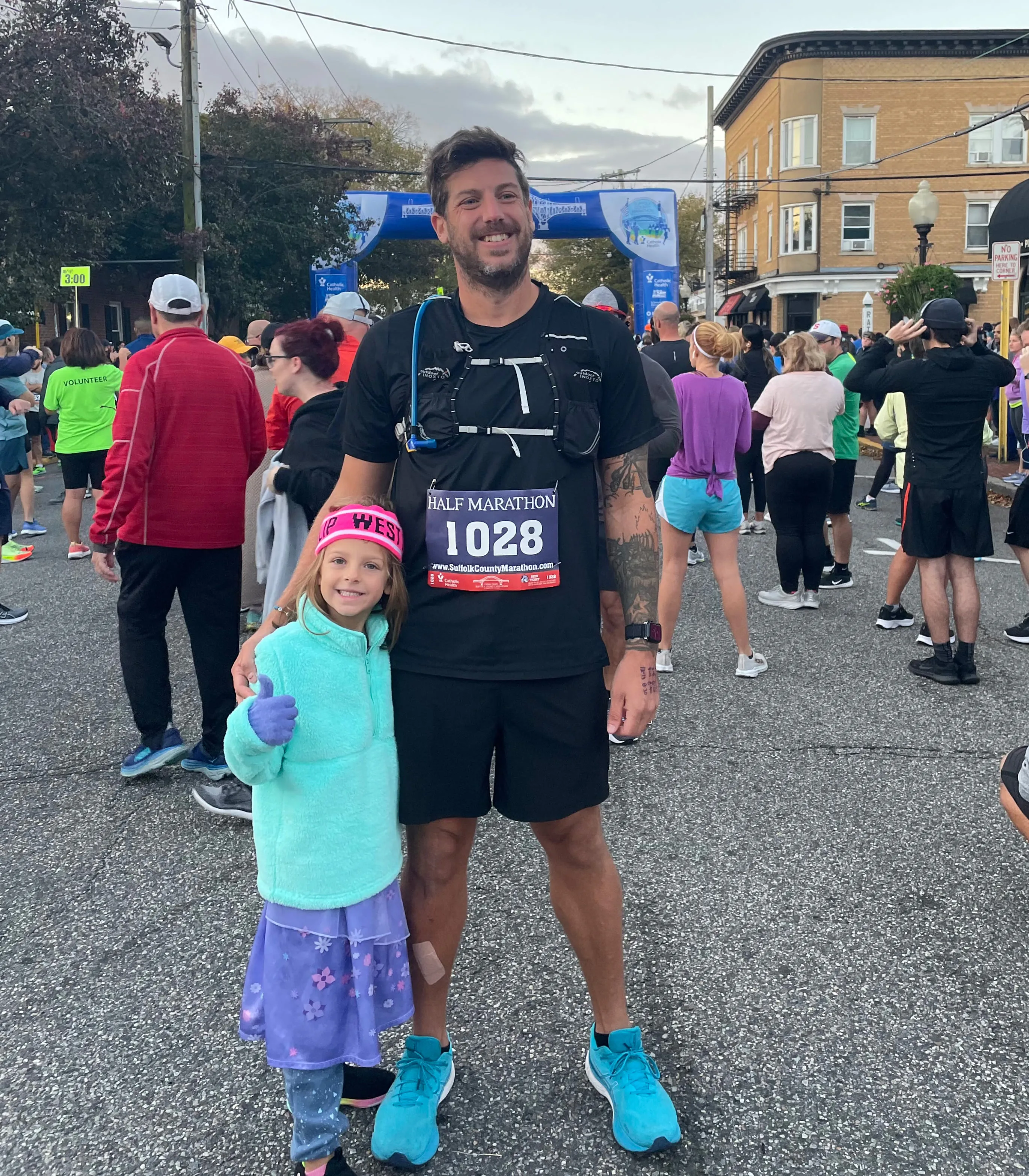 John and his dauther standing on the street behind the start line before the race