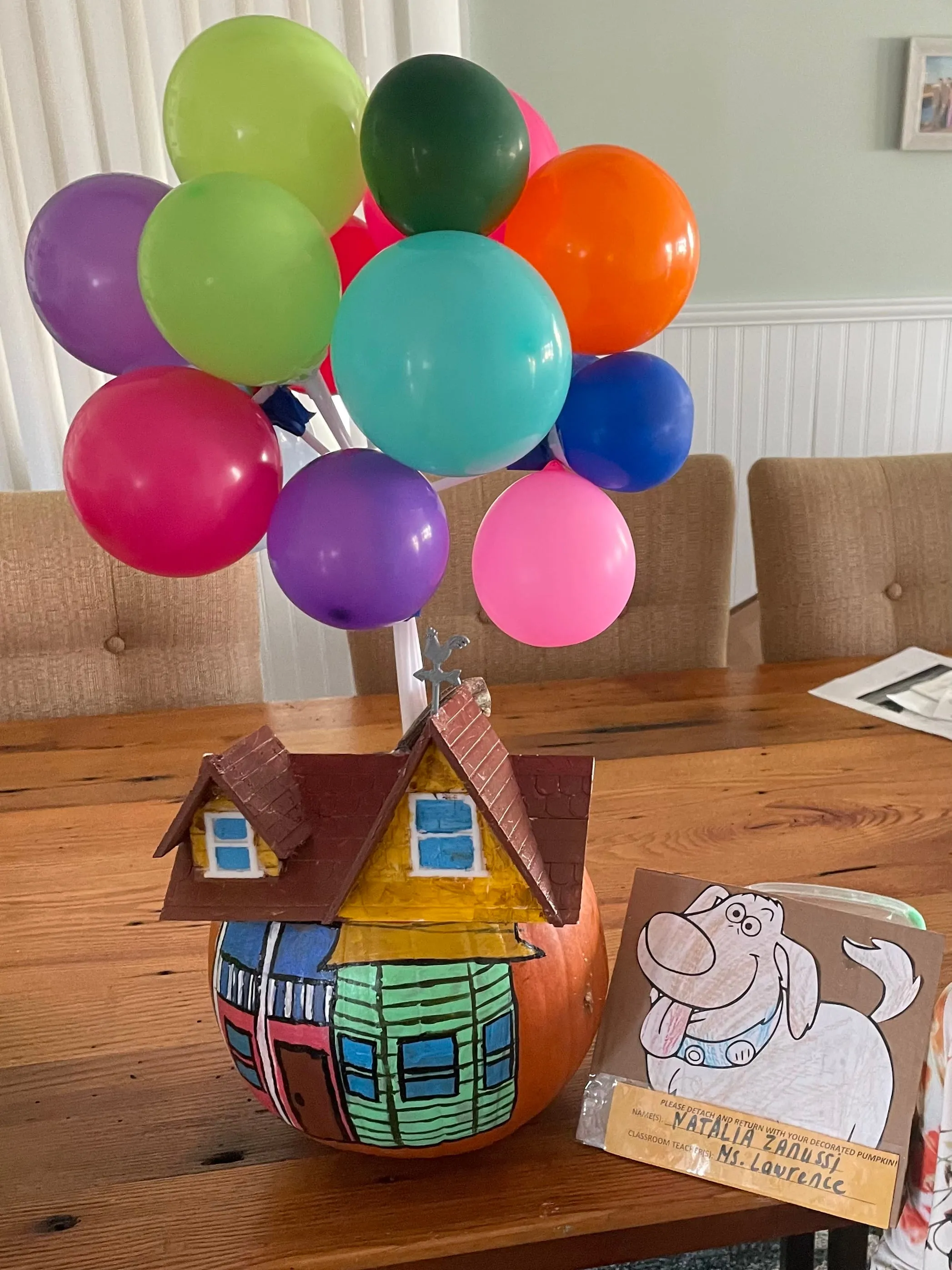 Pumpkin painted like the house from the movie Up with balloons on top of it