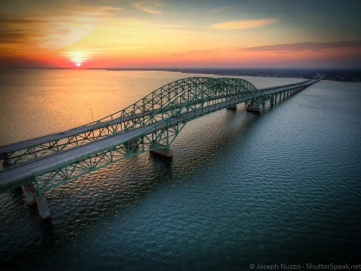 Aerial view of the Robert Moses Bridge and the Great South Bay with the sunset in the background